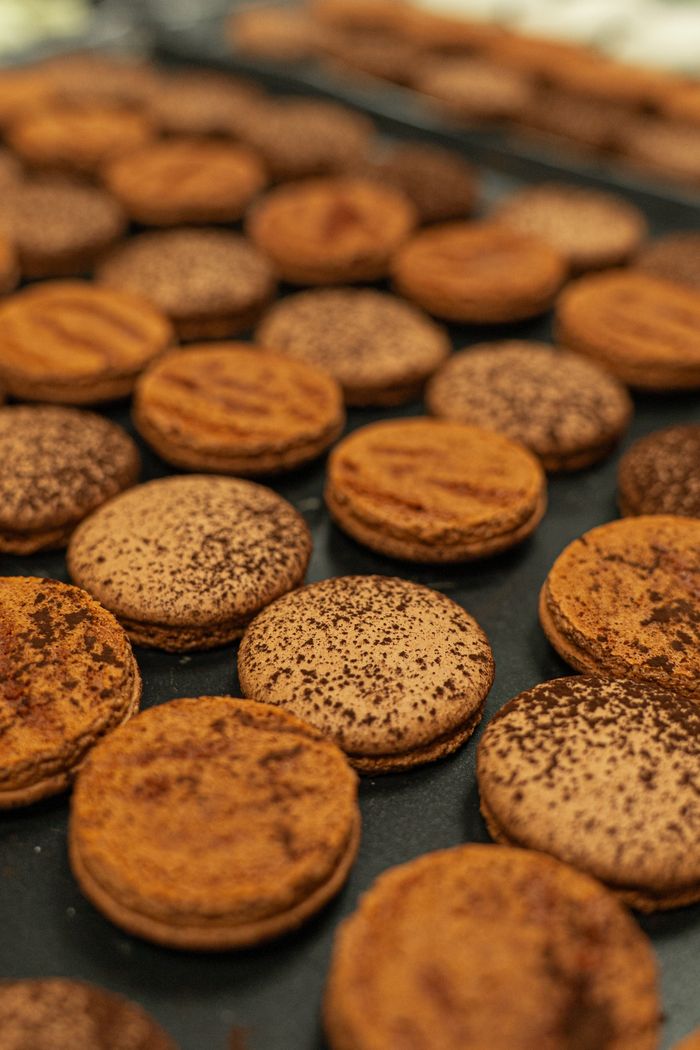 Close-up of freshly baked chocolate macarons with a rich texture, perfect for fine dining.